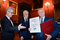 Zdjęcie zrobione w Auli Collegium Novum UJ podczas wręczenia tytułów Małopolanin Roku oraz Człowiek Roku edycji 2019 i 2020. Od lewej stoją Rektor UJ prof. Jacek Popiel, Kazimierz Barczyk, prof. Tadeusz Słomka. Panowie ubrani są w ciemne garnitury, białe koszule i krawaty. Prof. Tadeusz Słomka trzyma w rękach dyplom oraz karykaturę autorstwa Ewy Barańskiej-Jamrozik. W tle ściana w odcieniach czerwieni ozdobiona portretami najważniejszych postaci związanych z Uniwersytetem. Jednym z obrazów jest wizerunek papieża Jana Pawła II.