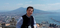 The photo shows a man with the panorama of Naples behind his back; Vesuvius volcano is in the background; on the right there is a gulf and the sea.